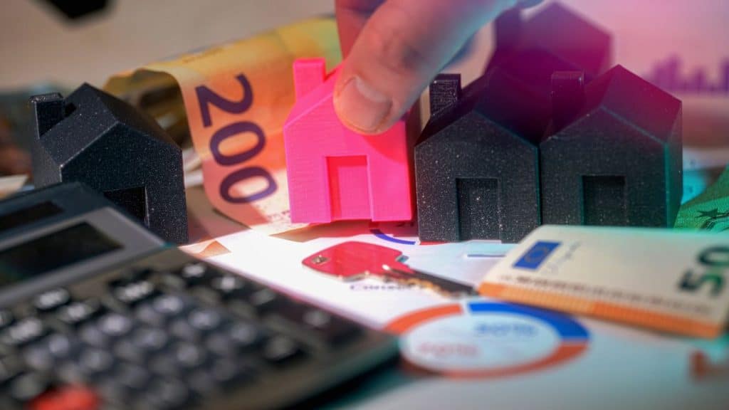 Miniature houses, euro bills, and calculator representing property management costs in Cape Town