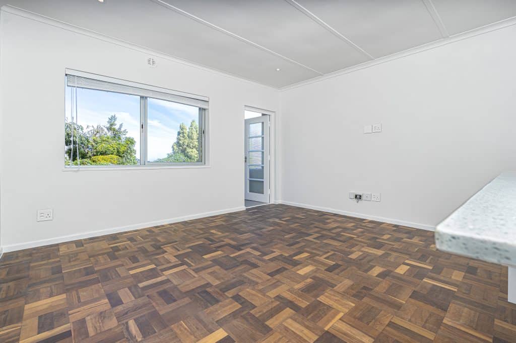 Empty, freshly presented living room with parquet floors in a Cape Town rental ready for viewings