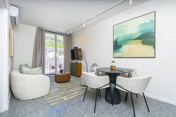 Unfurnished 1 bedroom apartment to rent in Sea Point, open plan lounge with glass doors to the balcony